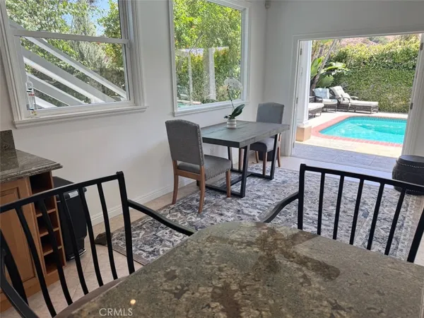 a view of a porch with furniture and backyard