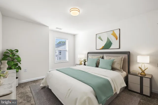 a bedroom with a bed and a potted plant