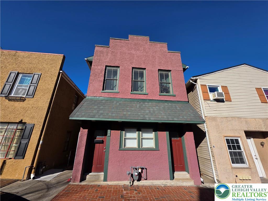 a front view of a house with many windows