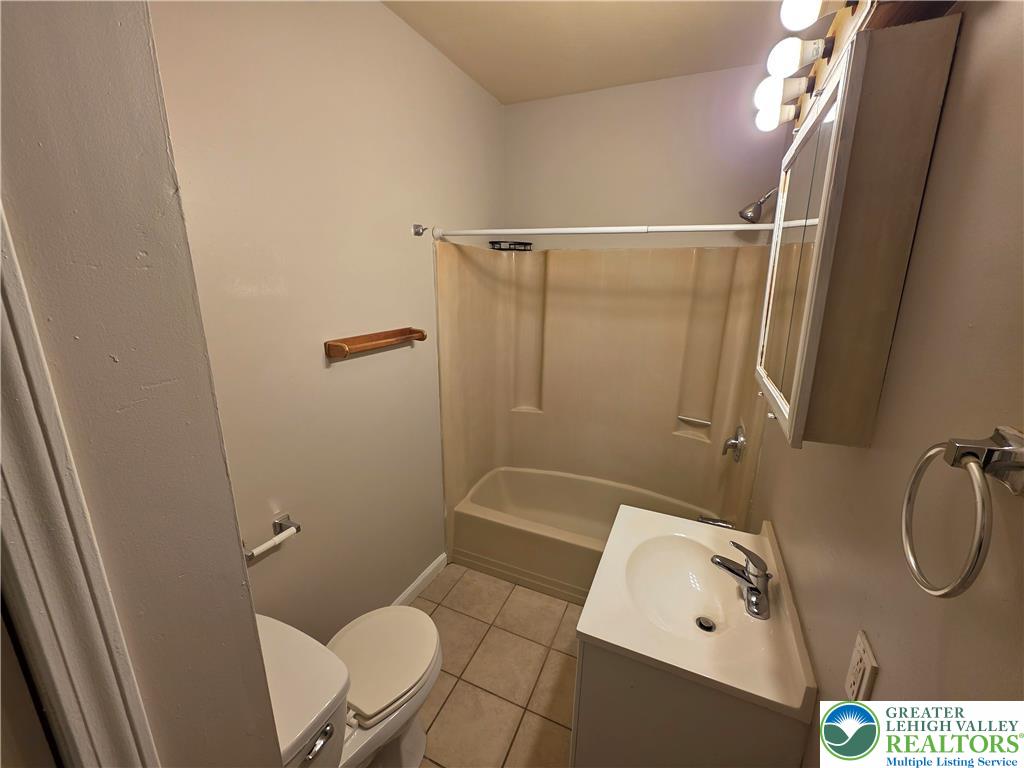 609 Walnut Street, Unit A Easton, PA 18042 - Photo 6 of 8 a bathroom with a shower a toilet and a sink