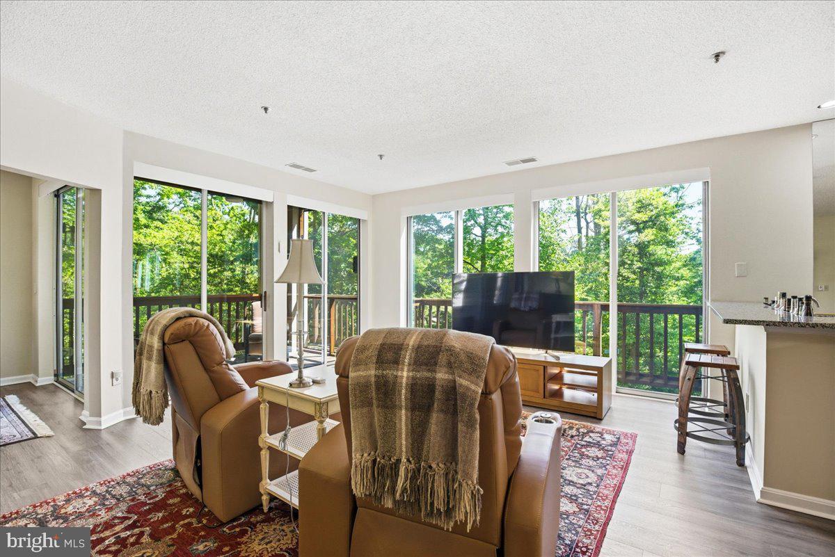 1126 Back Creek Loop, Unit 1126 Solomons, MD 20688 - Photo 18 of 47 a living room with furniture and a large window