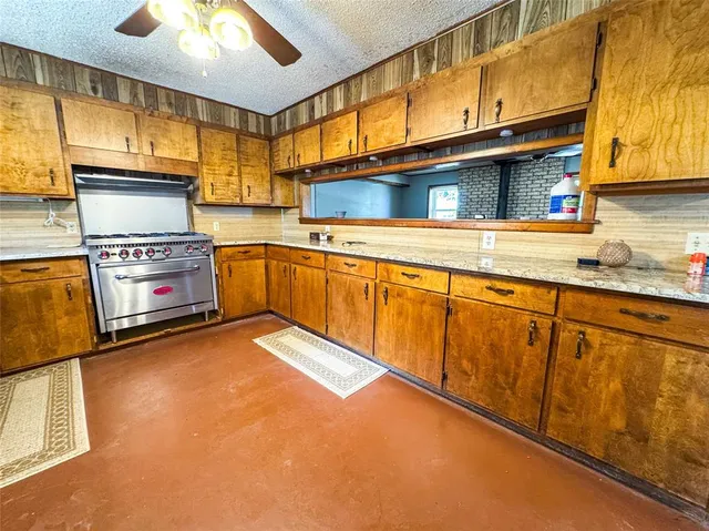 a kitchen with stainless steel appliances granite countertop a stove and a sink