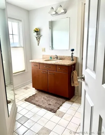 a bathroom with a sink vanity and mirror
