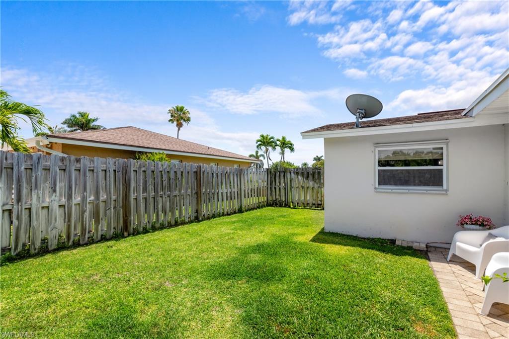 109 Doral Circle Naples, FL 34113 - Photo 14 of 17 Right Yard - Sitting area & room for pets to play