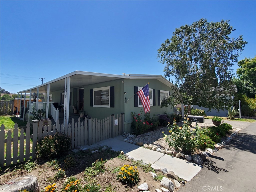 16274 Vasquez Canyon Road, Unit 54 Canyon Country, CA 91351 - Photo 1 of 1 a front view of a house with garden