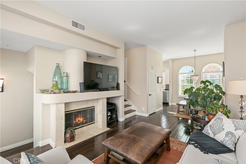 10 Crivelli Aisle Irvine, CA 92606 - Photo 5 of 28 Living room has cozy fireplace with gas logs