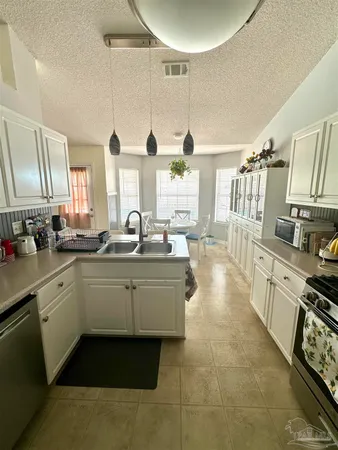 a large white kitchen with a large window