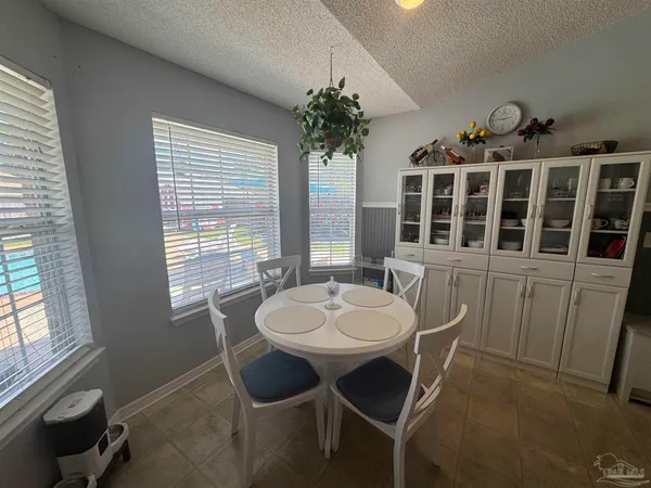 a dining room with furniture window and wooden floor