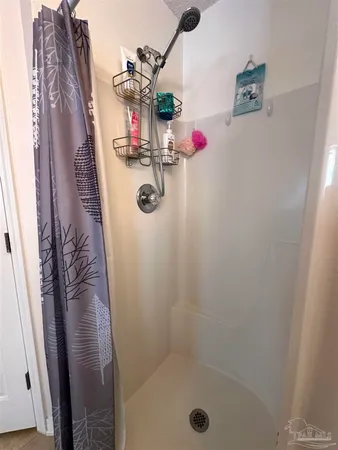 a bathroom with a toilet and a shower