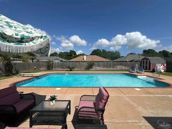 a view of a backyard with sitting area