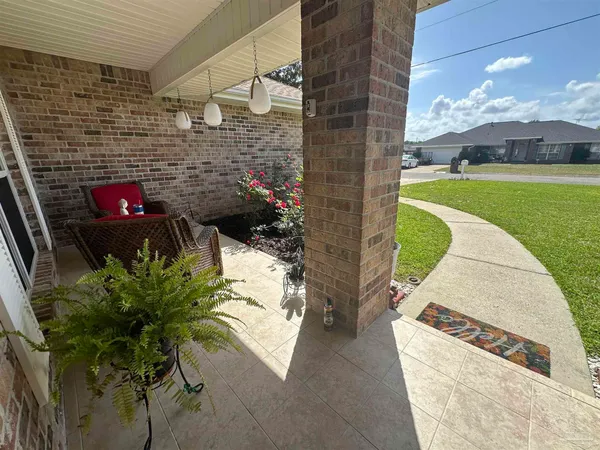 a view of a patio with table and chairs potted plants