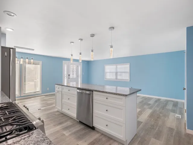 a view of a kitchen with kitchen sink and cabinets