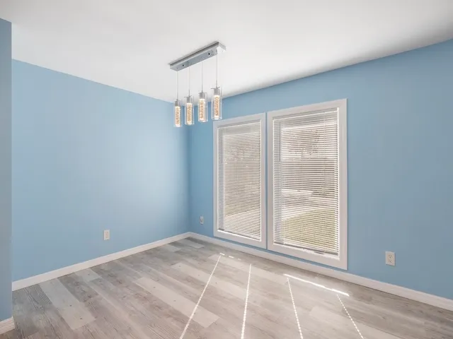 a bedroom with a bed and a potted plant