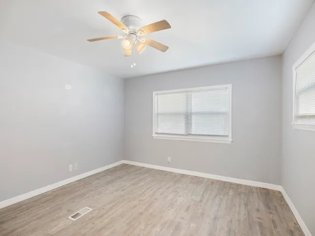 a bathroom with a granite countertop toilet sink shower and mirror