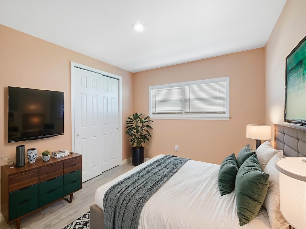 953 Laurel Circle Sebastian, FL 32976 - Photo 24 of 33 a bedroom with a bed and a flat screen tv