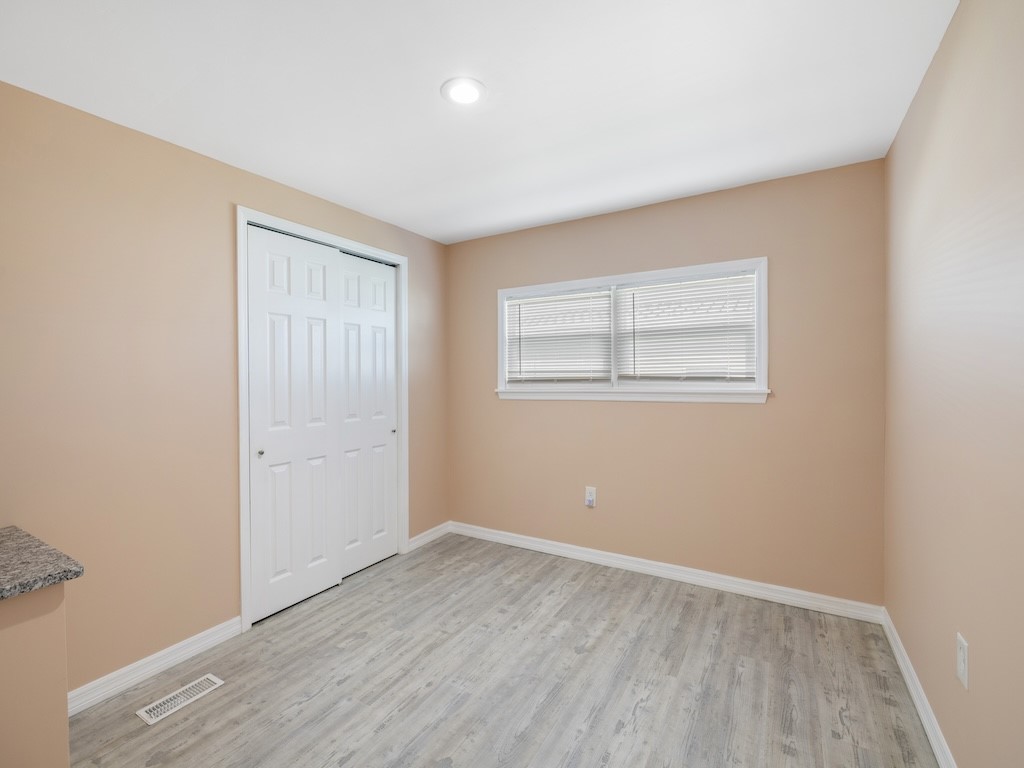 953 Laurel Circle Sebastian, FL 32976 - Photo 25 of 33 an empty room with wooden floor and windows