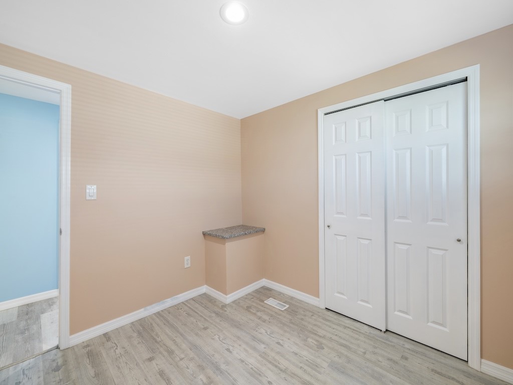 953 Laurel Circle Sebastian, FL 32976 - Photo 26 of 33 an empty room with wooden floor and closet