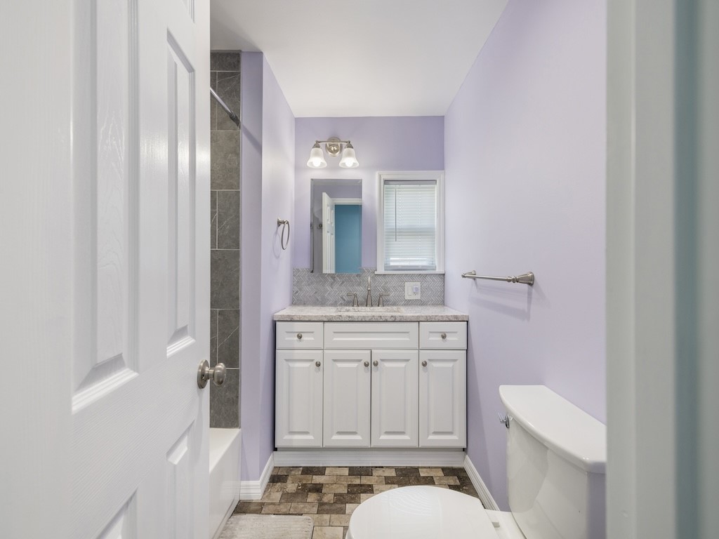 953 Laurel Circle Sebastian, FL 32976 - Photo 27 of 33 a bathroom with a sink a toilet and shower curtain