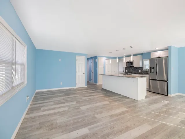 a view of a kitchen with a sink and a window