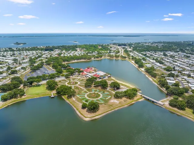 a front view of a house with a garden and yard