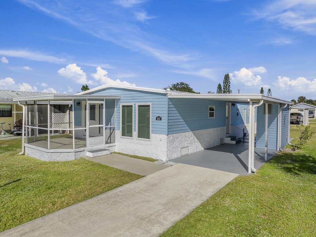 953 Laurel Circle Sebastian, FL 32976 - Photo 33 of 33 a front view of a house with a garden and yard