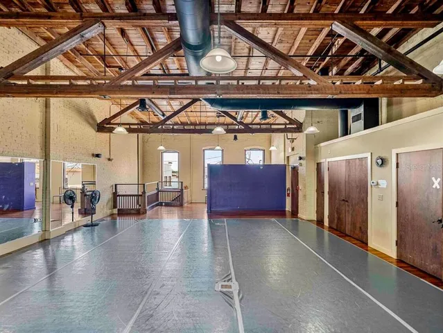 a view of a balcony with furniture and wooden floor