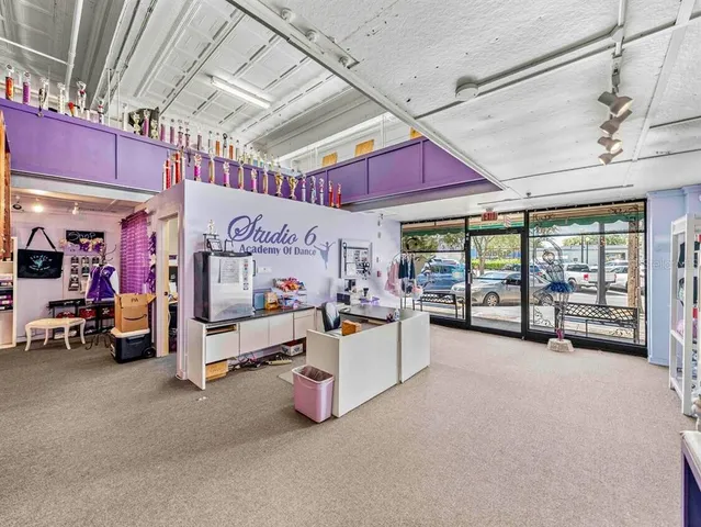 a view of a room with lot of bed and a large window