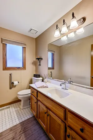 a bathroom with a double vanity sink and a mirror