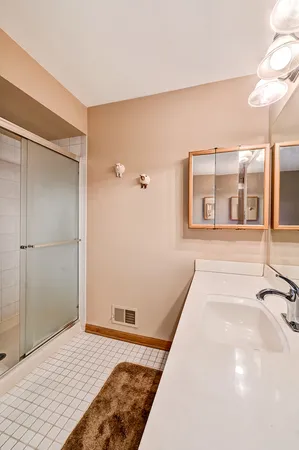 a spacious bedroom with a bed and glass door