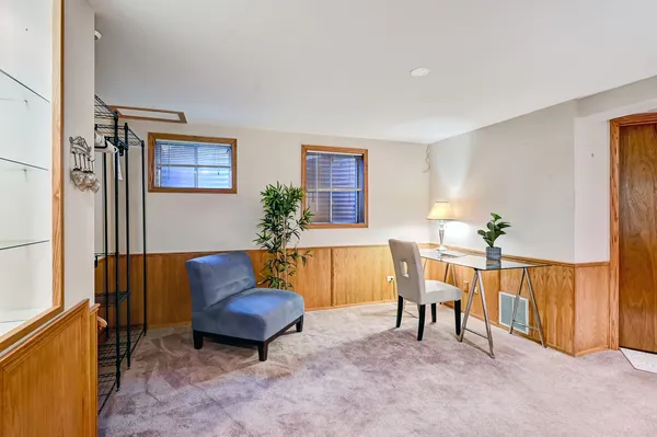 a living room with furniture and a potted plant