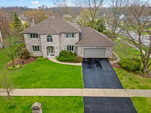 an aerial view of a house with a yard