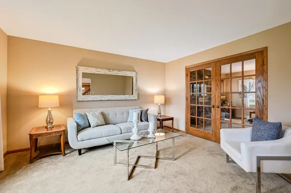 a living room with furniture and floor to ceiling windows