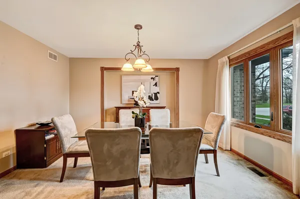 a view of a dining room with furniture window and outside view