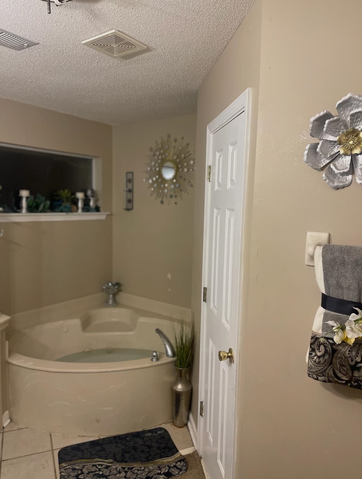 4499 Kings Station Road Millington, TN 38053 - Photo 4 of 4 Full bath featuring a garden tub, visible vents, a textured ceiling, and tile patterned floors