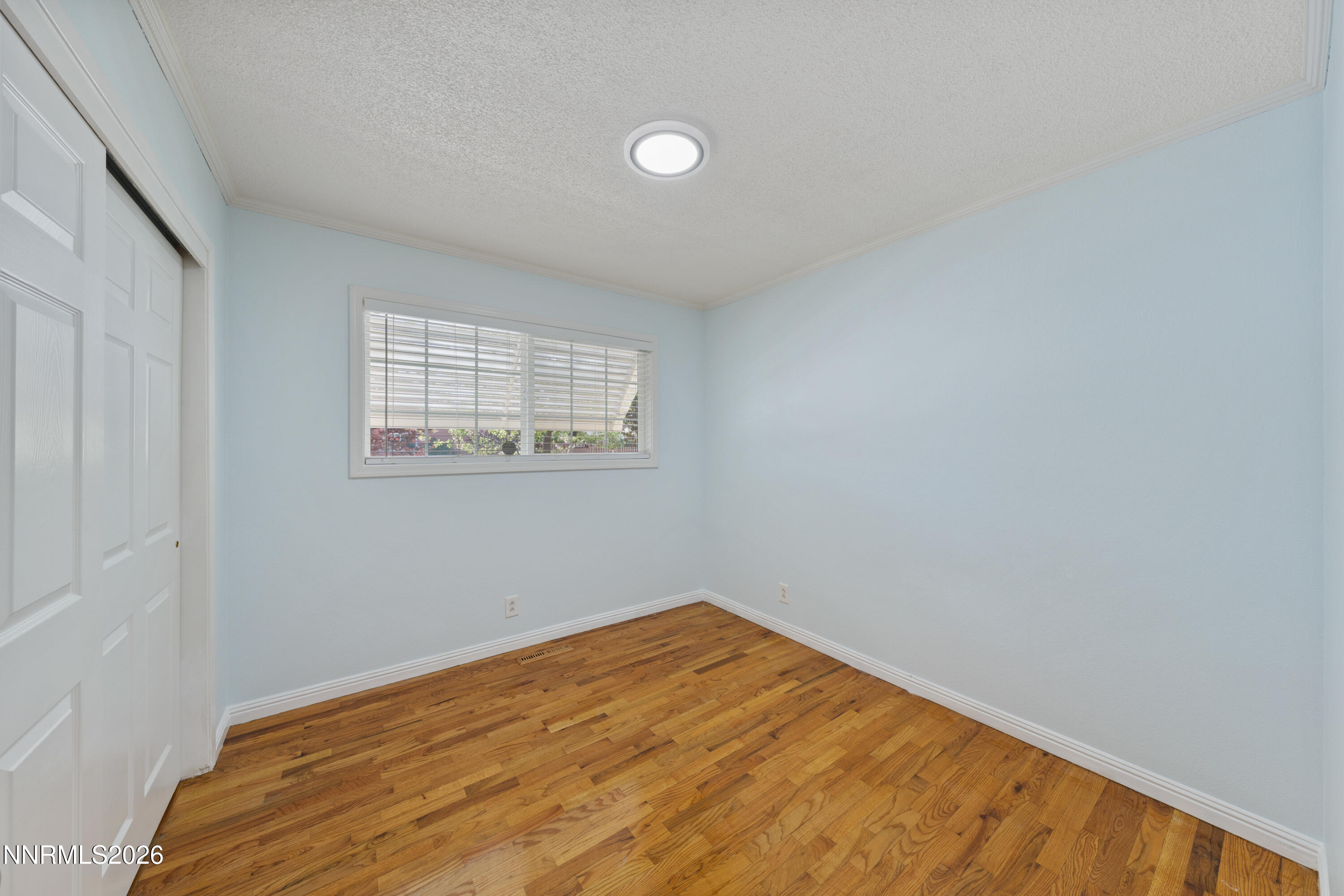 1540 Tyler Way Sparks, NV 89431 - Photo 13 of 30 a view of empty room with wooden floor and fan