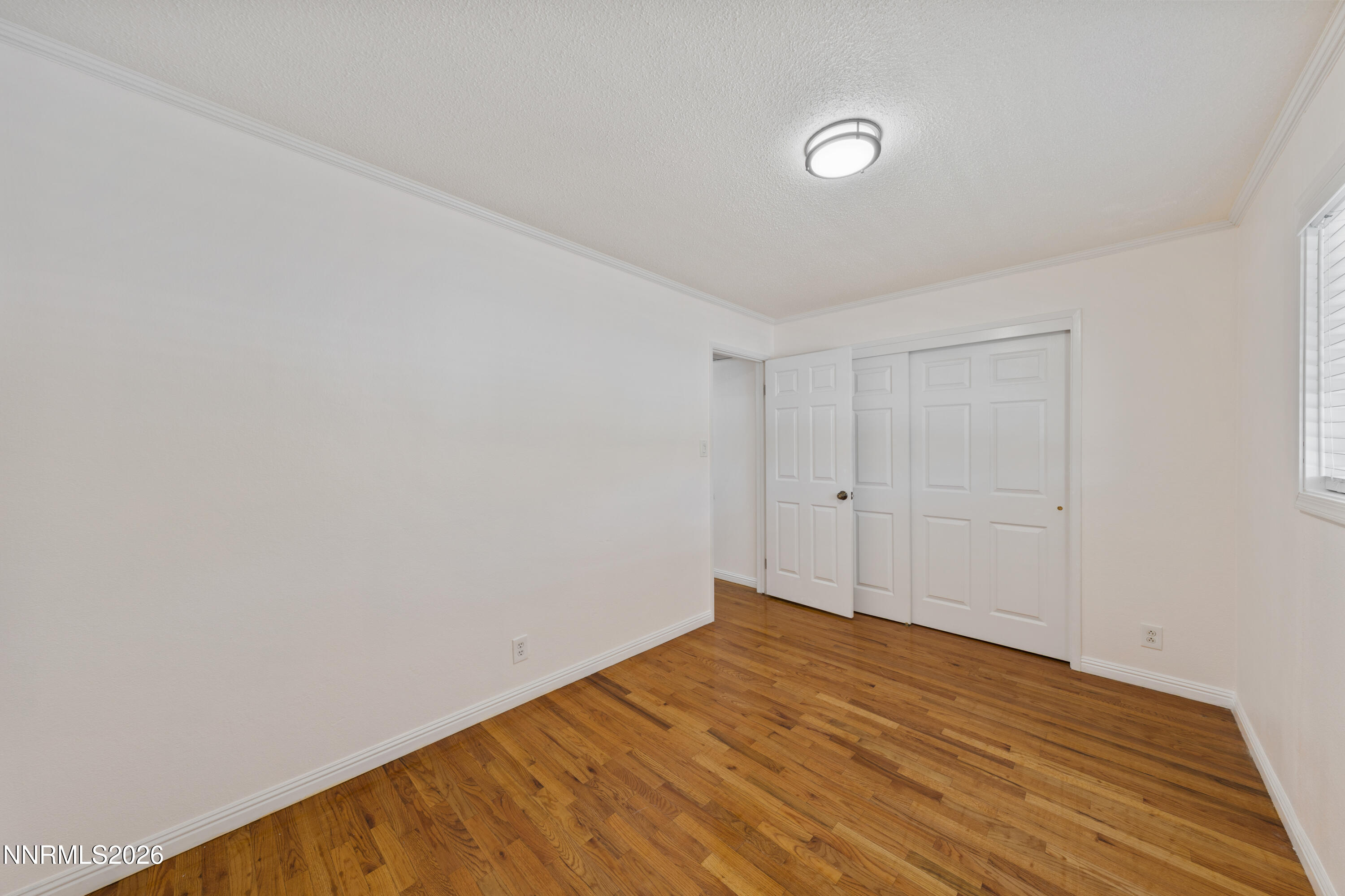 1540 Tyler Way Sparks, NV 89431 - Photo 15 of 30 a view of empty room with wooden floor