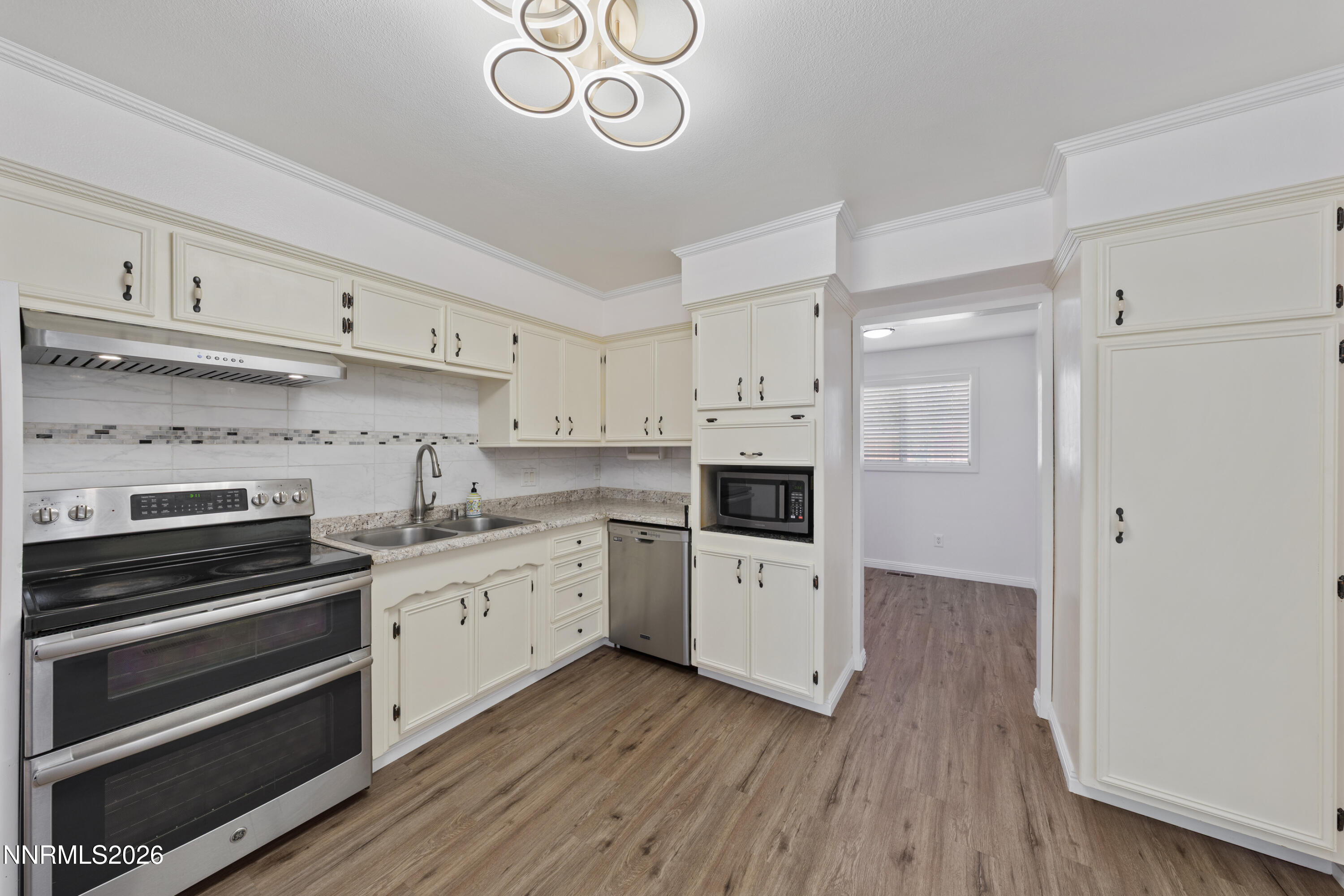 1540 Tyler Way Sparks, NV 89431 - Photo 2 of 30 a kitchen with cabinets wooden floor and a sink