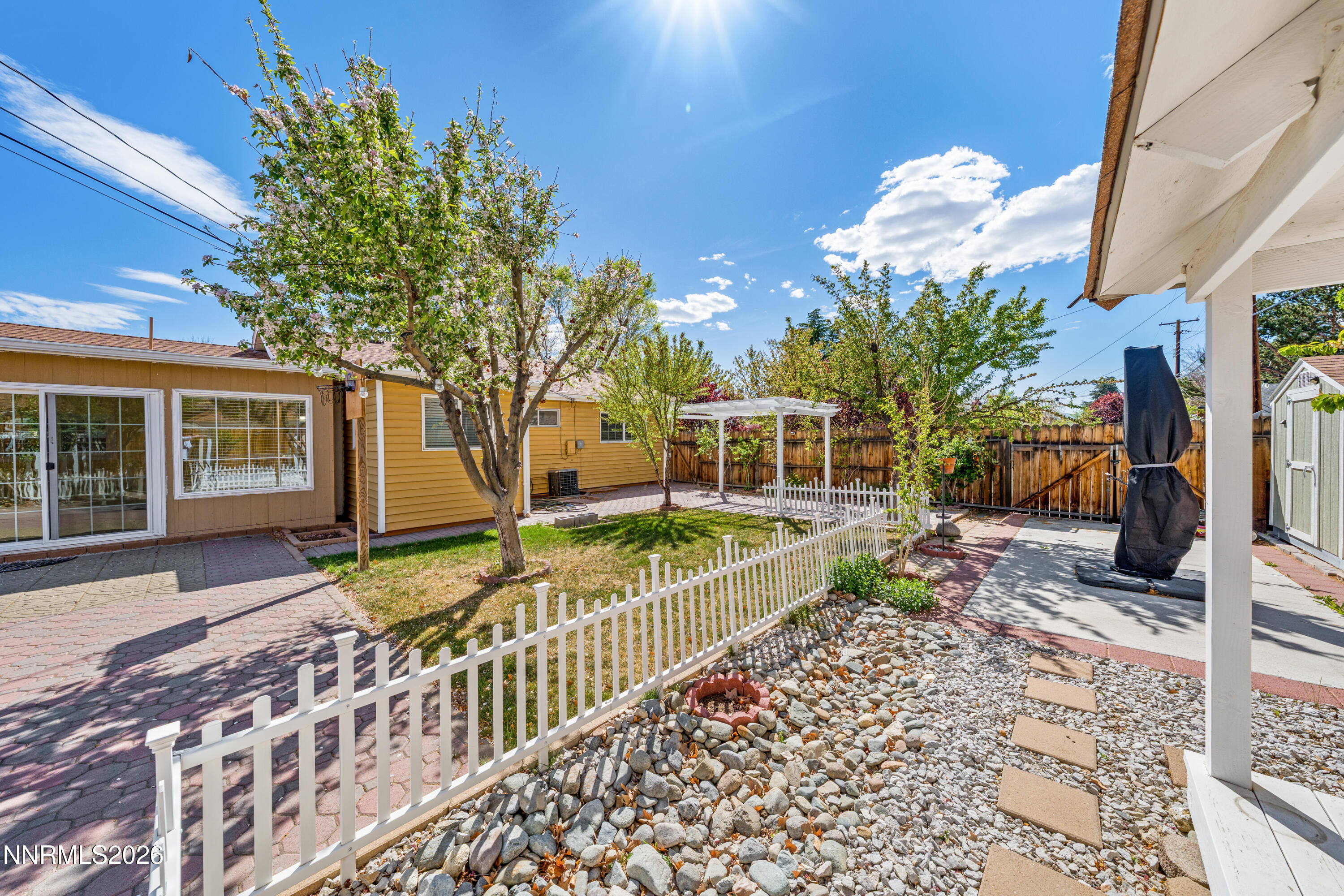 1540 Tyler Way Sparks, NV 89431 - Photo 22 of 30 a view of a house with a small yard and wooden fence
