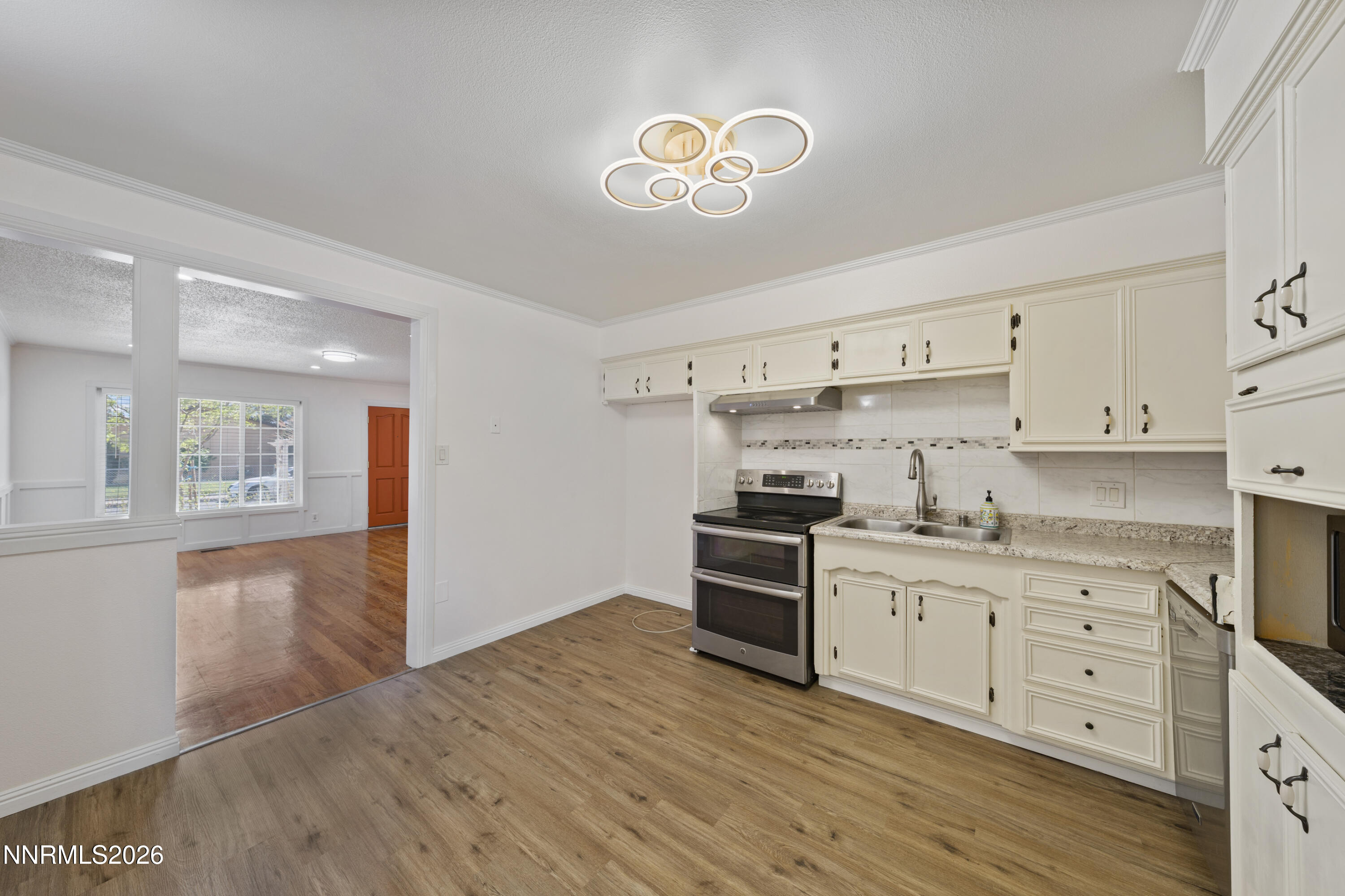 1540 Tyler Way Sparks, NV 89431 - Photo 3 of 30 a kitchen with granite countertop a sink cabinets and wooden floor