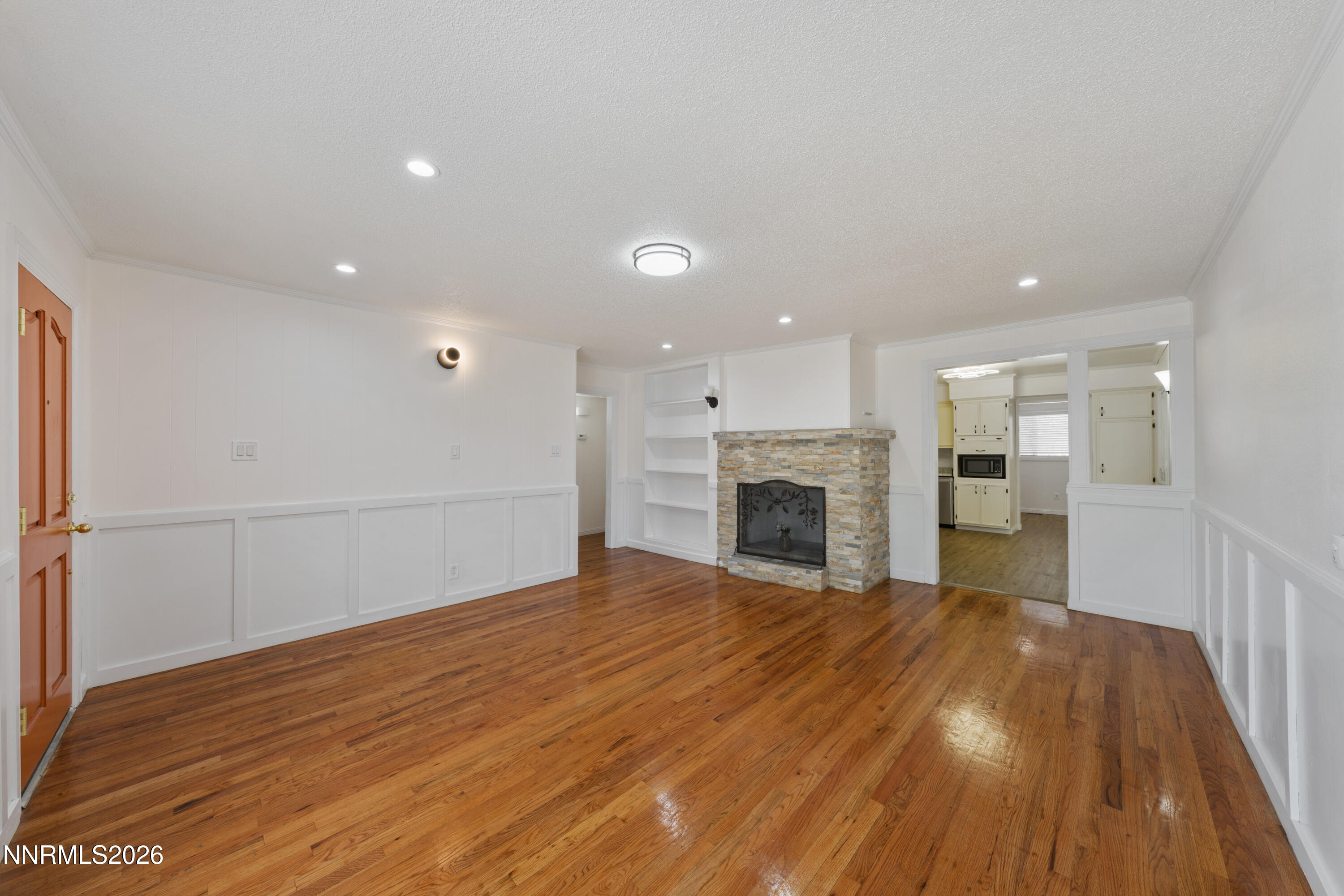 1540 Tyler Way Sparks, NV 89431 - Photo 4 of 30 a view of empty room with wooden floor and fireplace