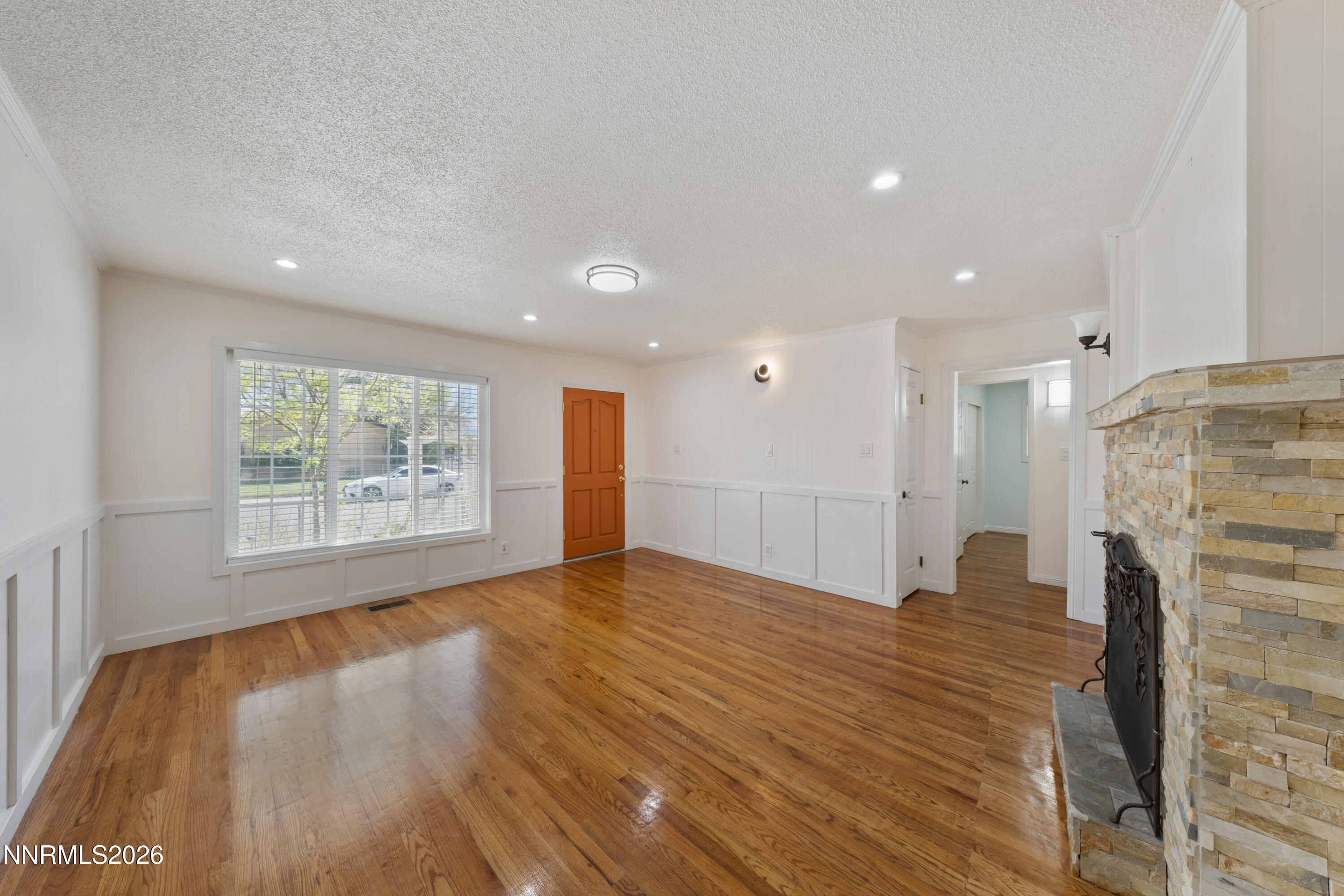 1540 Tyler Way Sparks, NV 89431 - Photo 5 of 30 a view of an empty room with wooden floor and a window