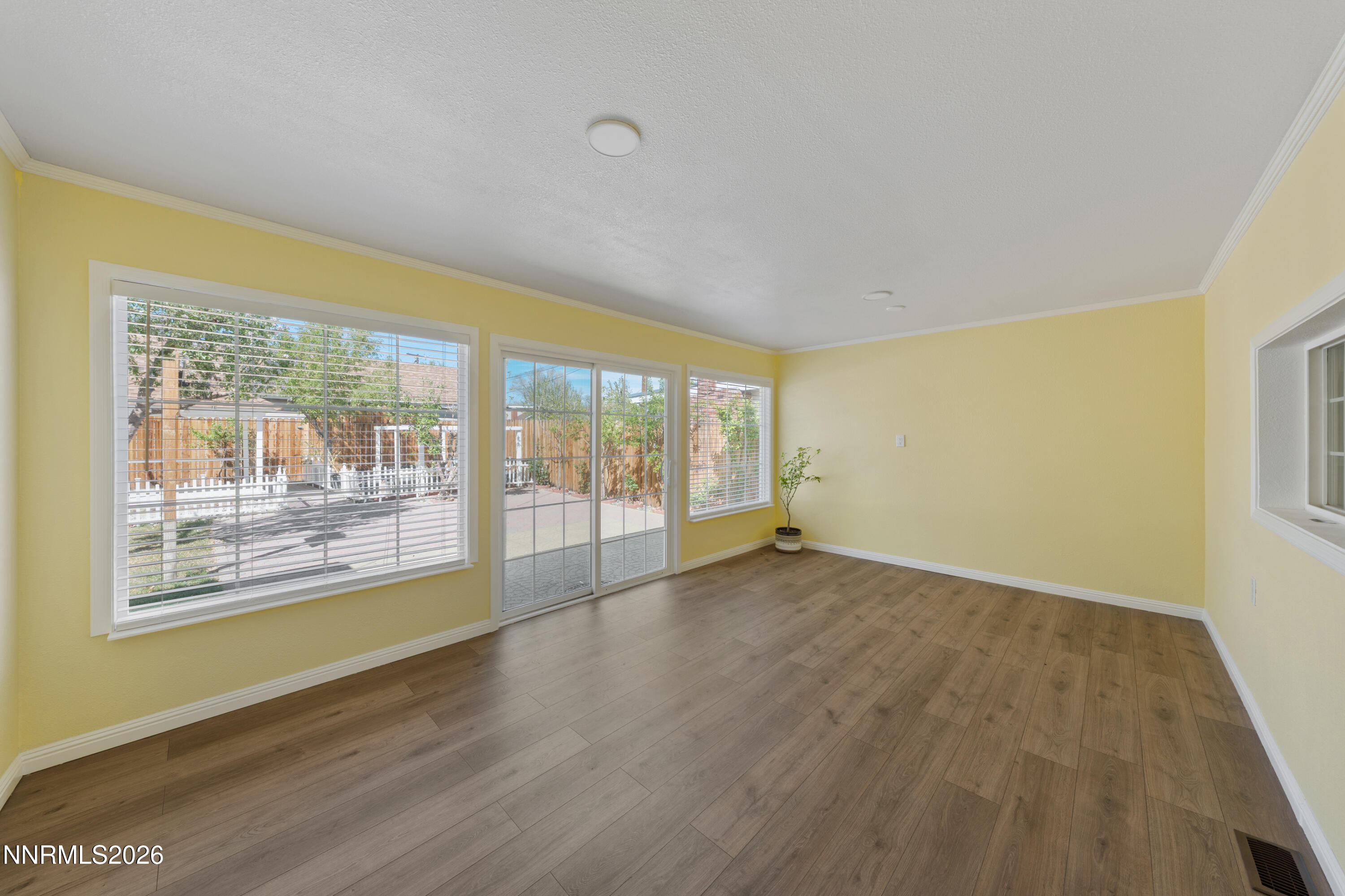 1540 Tyler Way Sparks, NV 89431 - Photo 7 of 30 a view of an empty room with wooden floor and a window