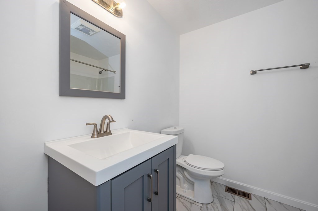 20 May Brook Road Holland, MA 01521 - Photo 11 of 28 a bathroom with a toilet a sink a vanity and mirror