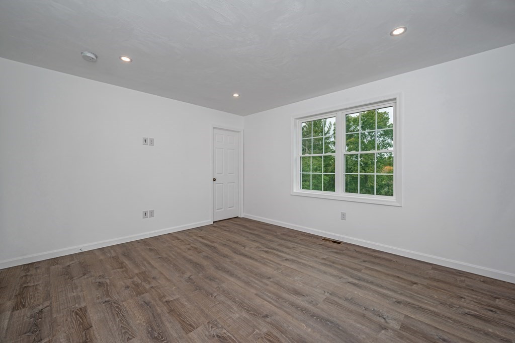 20 May Brook Road Holland, MA 01521 - Photo 13 of 28 an empty room with wooden floor and windows