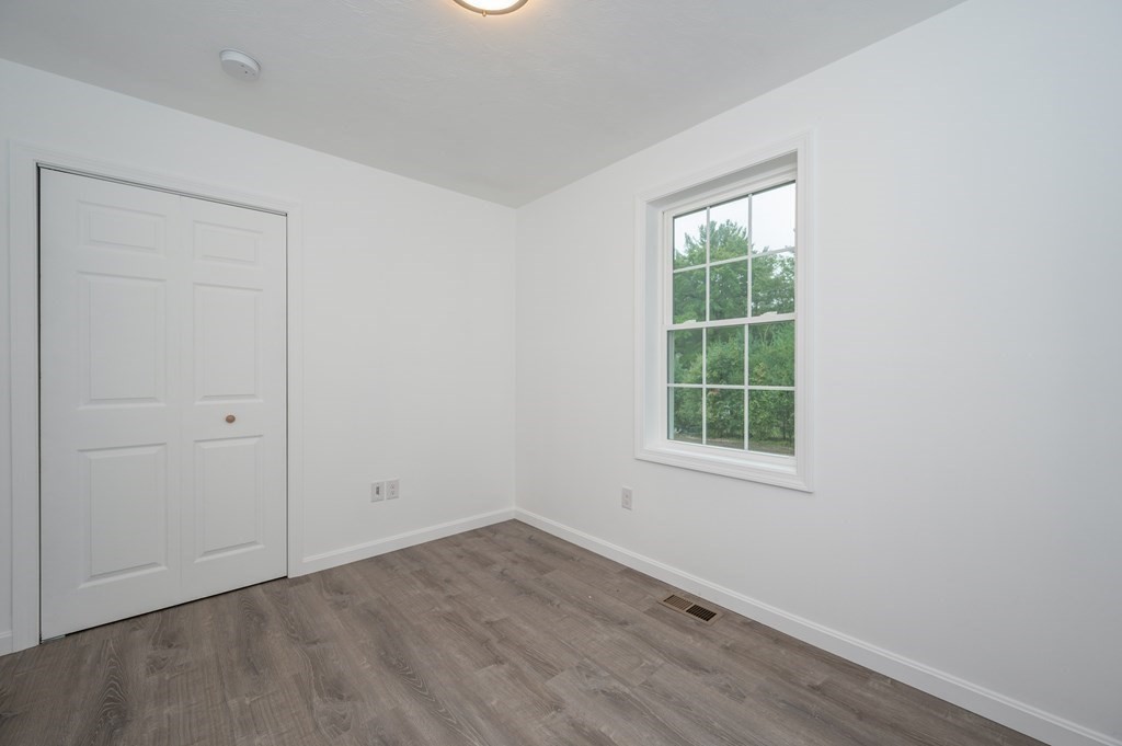 20 May Brook Road Holland, MA 01521 - Photo 16 of 28 an empty room with wooden floor and windows