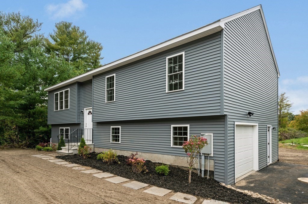 20 May Brook Road Holland, MA 01521 - Photo 2 of 28 a front view of a house with garage