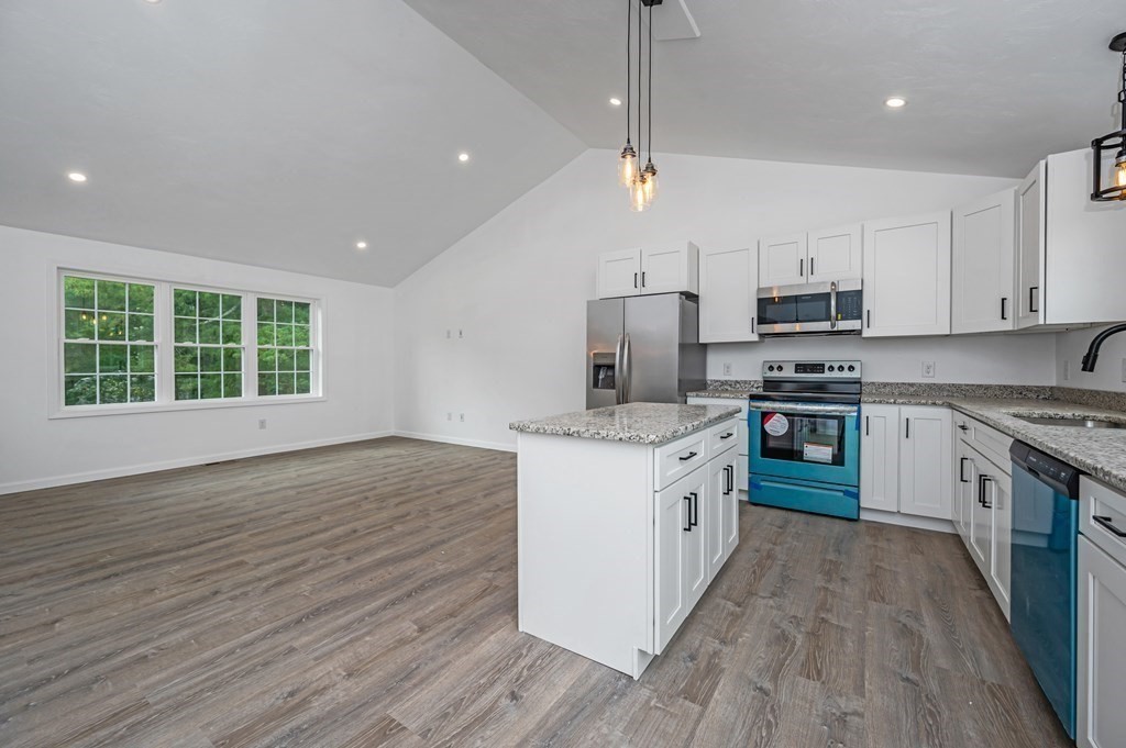 20 May Brook Road Holland, MA 01521 - Photo 8 of 28 a kitchen with stainless steel appliances granite countertop a stove a sink dishwasher a refrigerator and a oven with wooden floors