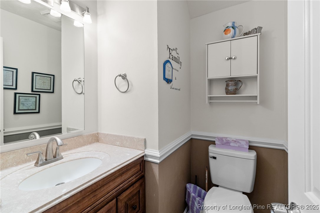 1912 Havilah Road Fayetteville, NC 28303 - Photo 13 of 21 a bathroom with a granite countertop toilet sink and mirror