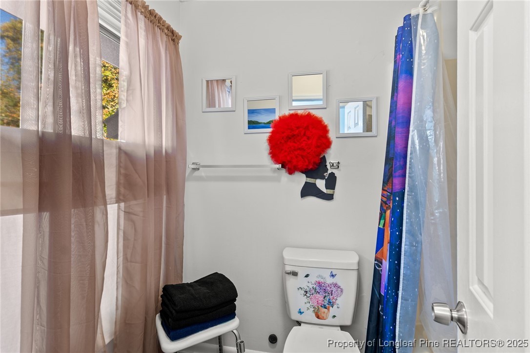 1912 Havilah Road Fayetteville, NC 28303 - Photo 17 of 21 a living room with furniture and a painting on the wall