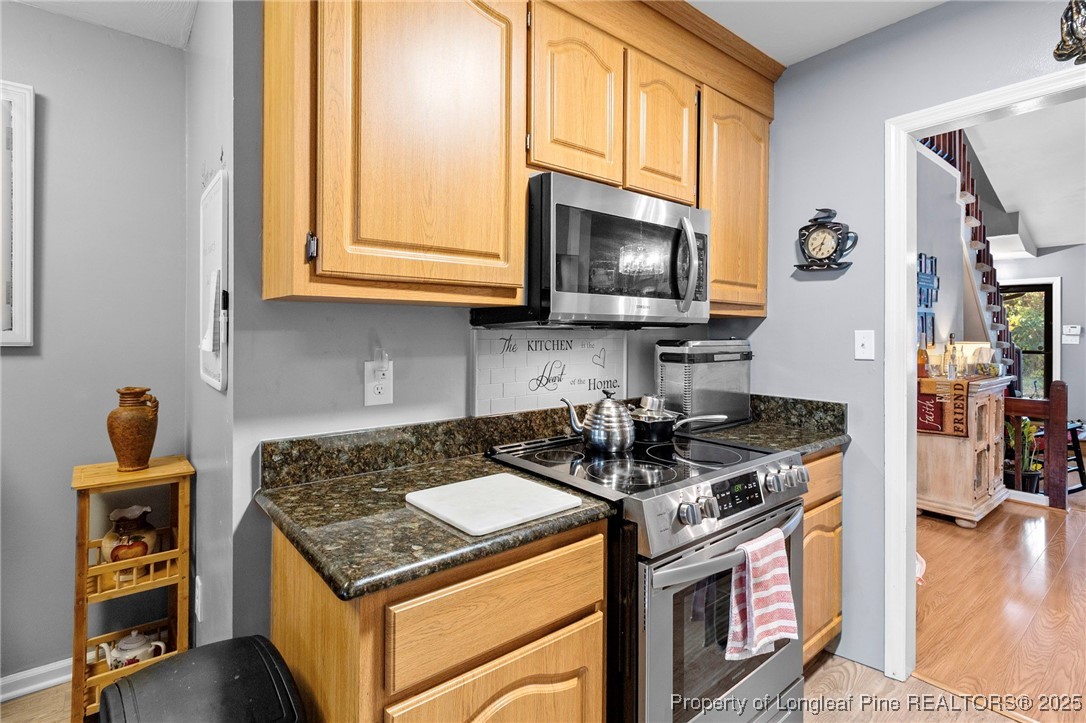 1912 Havilah Road Fayetteville, NC 28303 - Photo 10 of 21 a kitchen with stainless steel appliances granite countertop a stove and a microwave